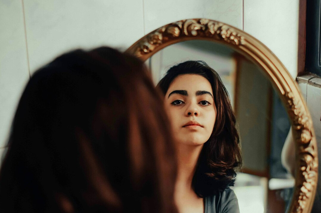 confident woman in mirror