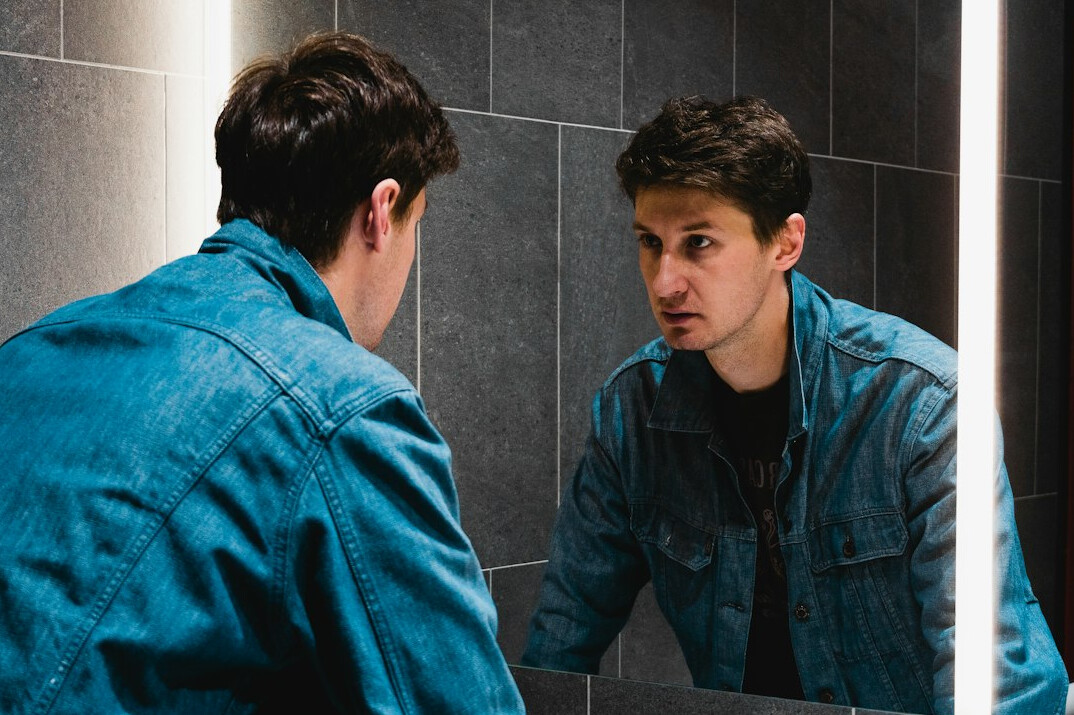 person looking in mirror confidently