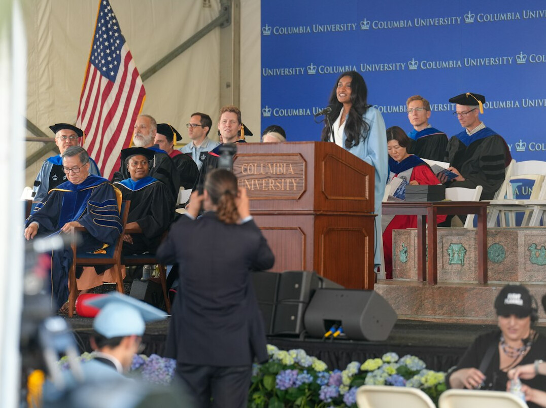 person speaking at podium on stage